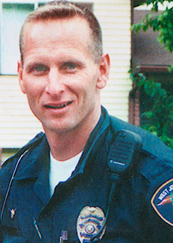Officer Ron Wood smiling in his uniform