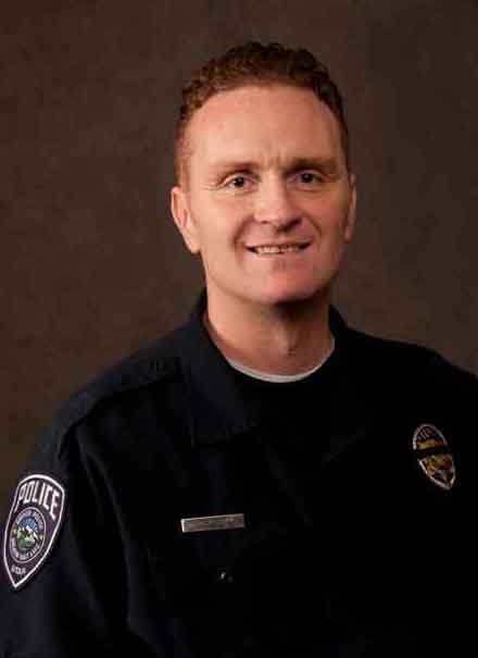 Officer Doug Barney smiling in his uniform