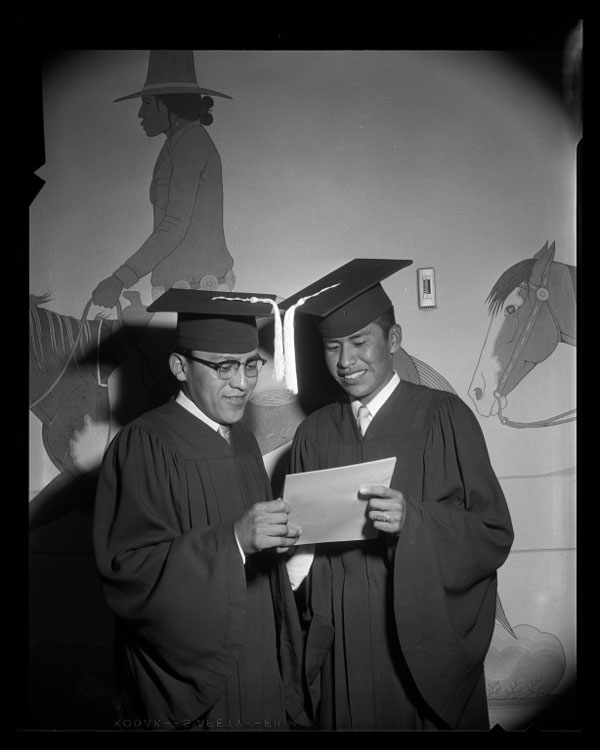 Two young men in graduation caps and gowns