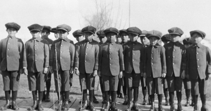 Historic photo of boys in matching uniforms