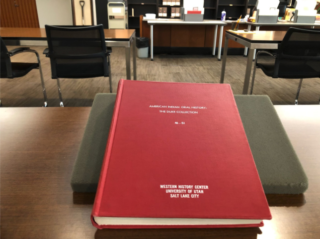 A red book stacked on a table